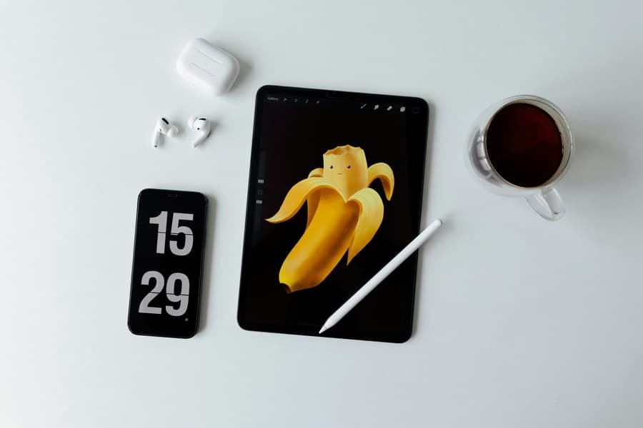 Digital illustration work on a tablet beside creator tools