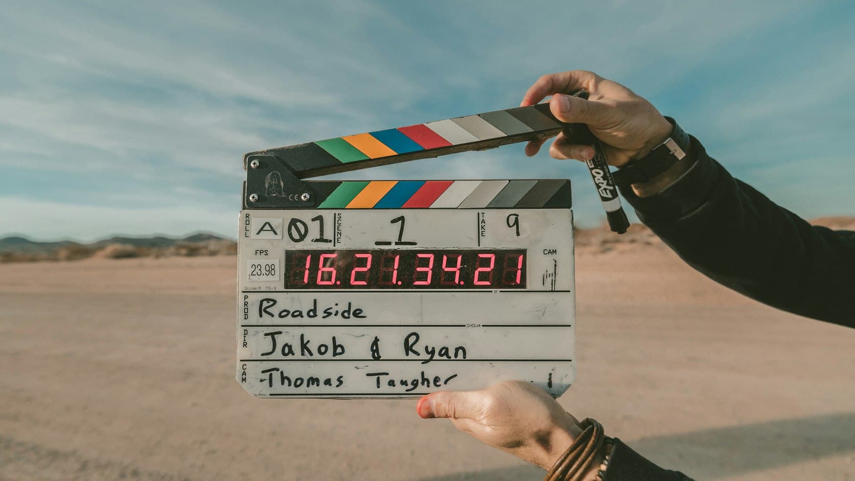 A producer holding a clapperboard on set